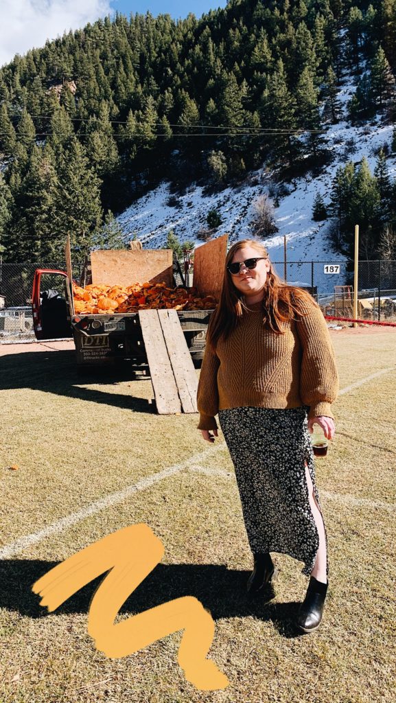 Posing casually in front of pumpkin remains.